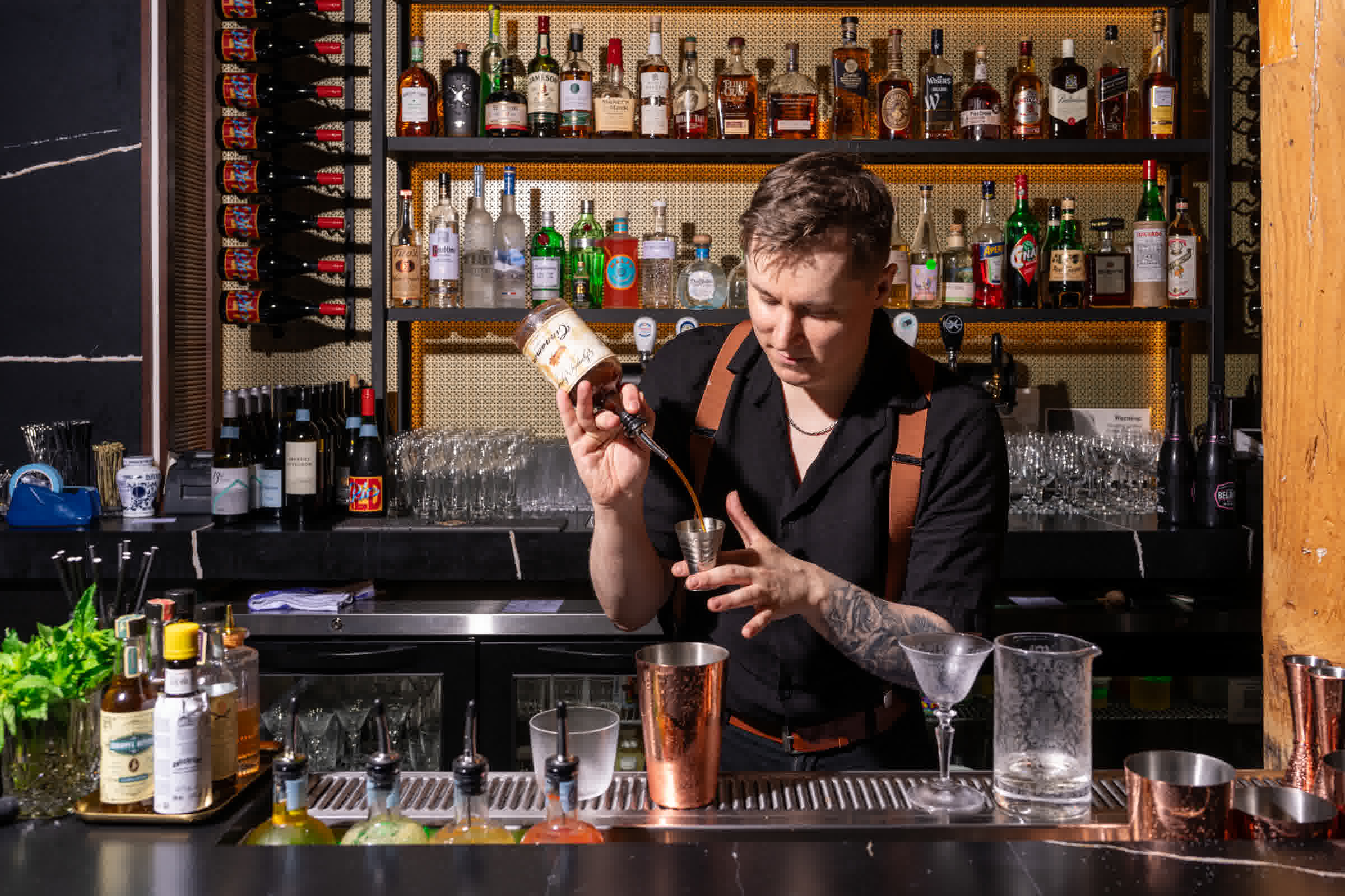 Bartender crafting cocktails at The Berczy Tavern